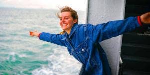 woman smiling off the side of a boat
