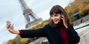woman taking selfie with eiffel tower