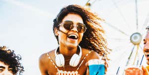 young woman laughing at an amusement park