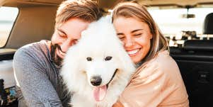 Couple hugging pretty dog