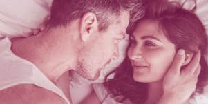 couple smiling on bed