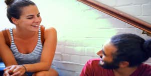 woman and man looking at each other in discussion on staircase