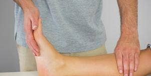 man examining leg