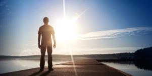 man standing in sun glare