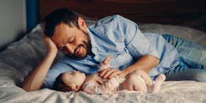Man with his baby on bed