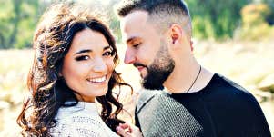 young man with beard looks lovingly at a young woman 