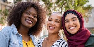 Three women hanging out together and smiling 