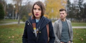 sad-looking woman with man behind her