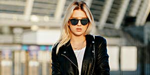 young woman looks nervous in sunglasses