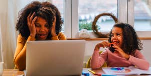 stressed mom working with daughter next to her