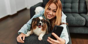 woman taking selfie with her dog