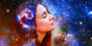 face of women meditating with nebula space-y background 