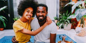 woman hugging husband as they sit on their back porch