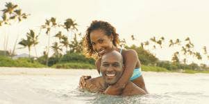 man and woman swimming in the ocean