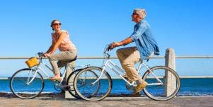 older man and woman biking