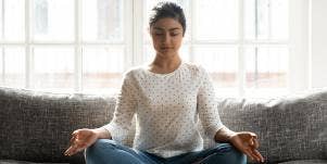 woman meditating on couch