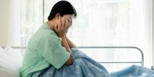 woman crying in hospital bed