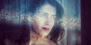 sad woman looking out the window