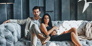 young fashionable couple on a modern sofa looking serious