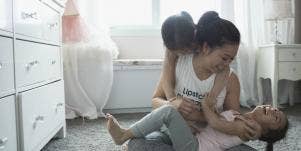 mom playing with child in nursery