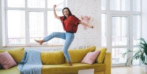 woman jumping on couch