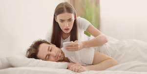 lady looking phone in shock, while man sleeping
