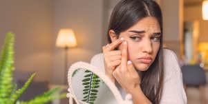 woman touching her face