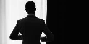 silhouette of man by window