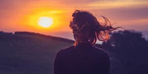woman standing in sunset