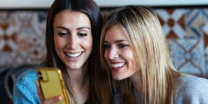 two women looking at phone screen