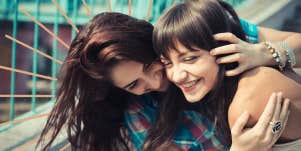 Two sister embracing being playful