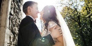 bride and groom kissing in sunlight