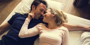 husband and wife embracing on bed