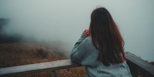 woman looking out at fog