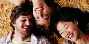 one man with two women lying down