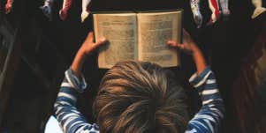 little boy reading book