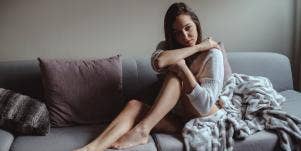 sad woman sitting on couch