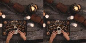 hands on planchette and ouija board
