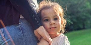 little girl holding her parent's hand