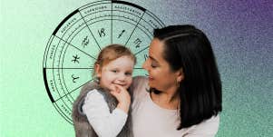 mother holding daughter and zodiac wheel