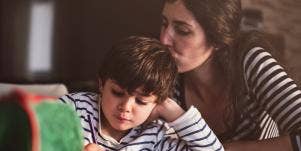 woman kissing child on head
