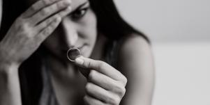 woman looking at engagement ring in black and white