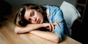 sad woman on a desk