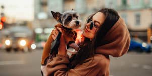 woman holding her dog