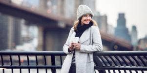 smiling woman looking out a bridge