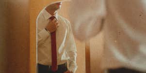 man standing in front of a mirror