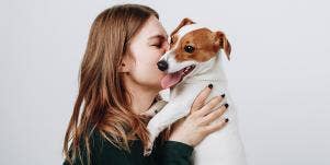 woman cuddling with dog