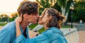 man and woman about to kiss outside