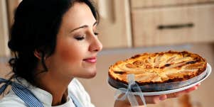 woman smelling fresh apple pie