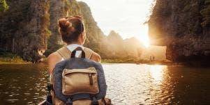 woman backpacking at sunset